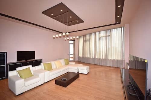 Apartment, 4 Bedrooms, Balcony, City View | Living area | 50-inch flat-screen TV with cable channels