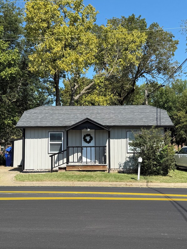 A small, single-story building with a dark roof and a front porch. - Fabulous 2 bedroom Bungalow in Charming Rose District, Downtown Broken Arrow (Broken Arrow)