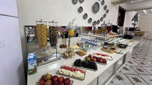 A buffet with various food items and beverages, including fruits, pastries, and dairy products. - Pakhlavon Boutique Hotel (Khiva)