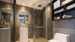 A modern bathroom with a glass-enclosed shower, a standalone sink, and a toilet. - Vista 1br | discounted stay | Citygate Kamala (Tambon Kammala)