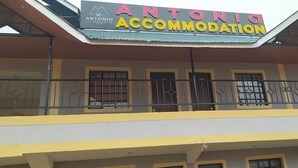 A building with a sign reading "ANTONIO ACCOMMODATION" and a balcony with metal railings. - Antonio Accommodation Kericho (Kericho)