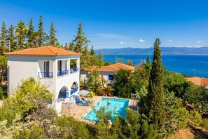 A villa with a swimming pool, a terrace, and a view of the sea. - Villa Cleo - Three Bedroom Villa, Sleeps 4 (Pilos Nestor)