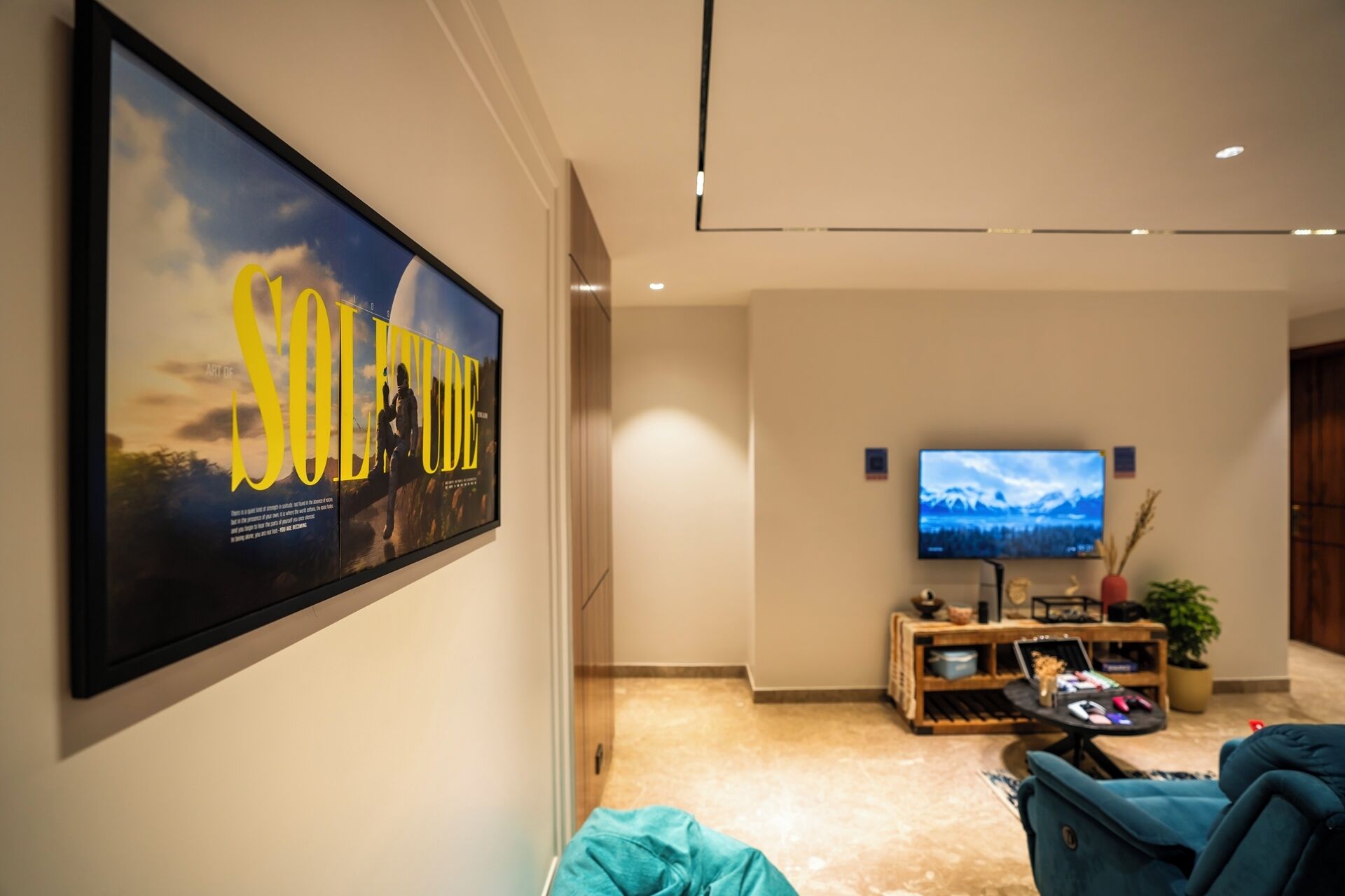 A modern living room with a large poster, a flat-screen TV, and a cozy seating area.