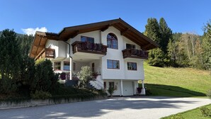 A two-story house with a balcony, a garage, and a driveway. - Matthiasgut - Tauernview S (Radstadt)