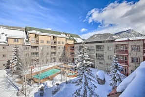 A hotel with multiple buildings, a swimming pool, and snow-covered surroundings.