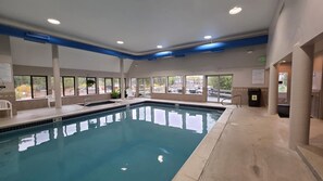 An indoor swimming pool with clear water, surrounded by windows and a tiled floor. - Keystone MTN Haven! (Keystone)