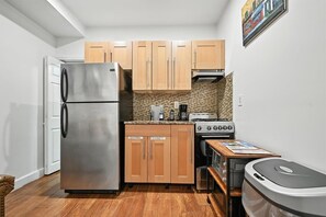 Fridge, microwave, coffee/tea maker, cookware/dishes/utensils