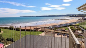 A balcony with a view of a beach and ocean. - Beachside (Paignton)