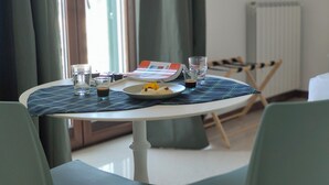 A dining table with a placemat, a plate with food, glasses, and a menu. - SEA DREAM PALACE 1 (Trani)