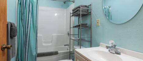 Un bagno con doccia, WC e lavandino.