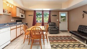 A compact living space with a kitchen, dining area, and seating area.