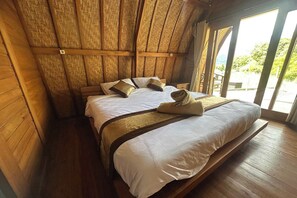 A wooden-framed room with a bed, large windows, and a view of greenery outside. - Nirwana Kintamani By Zuzu (Kintamani)
