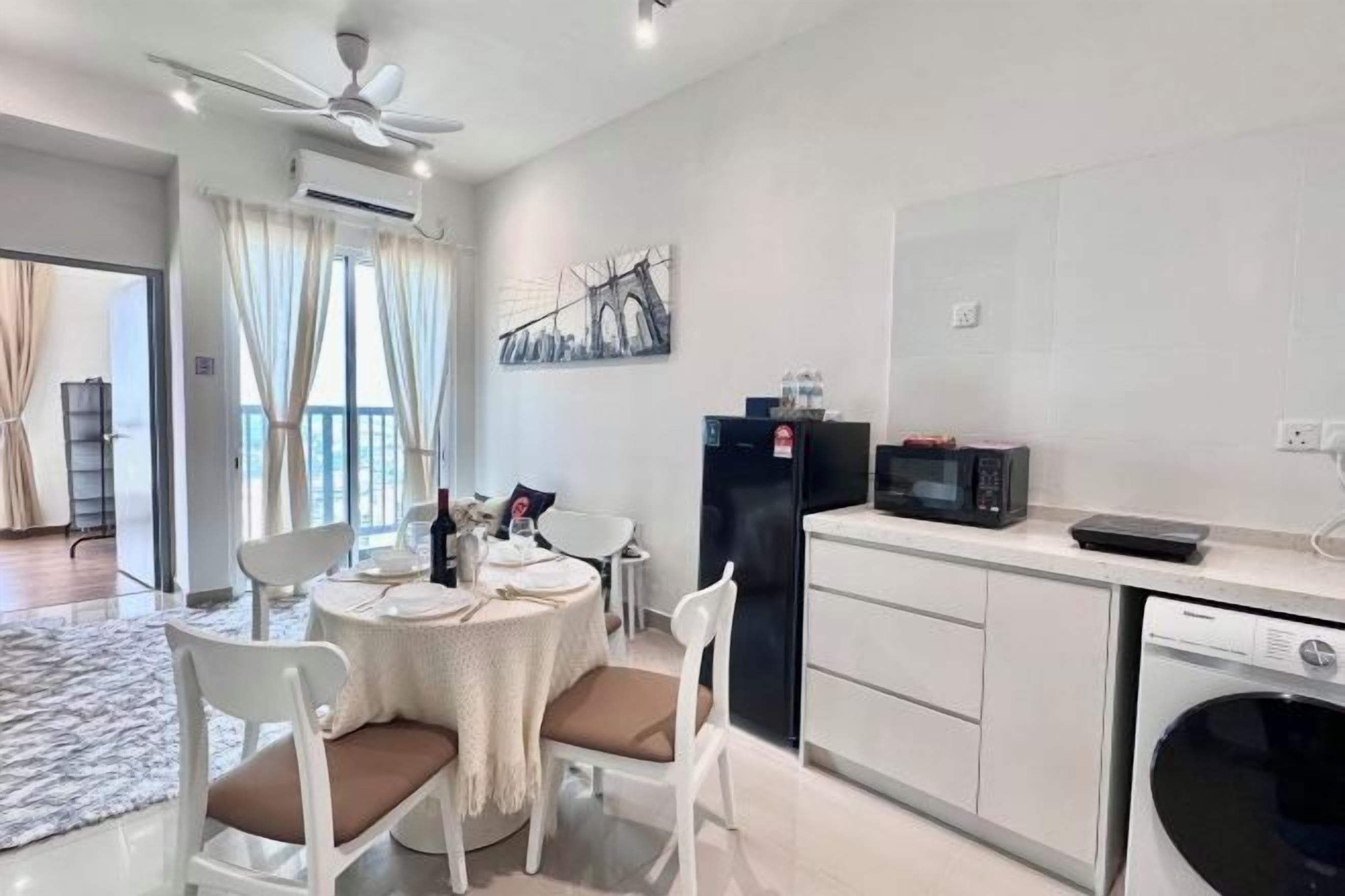 A modern kitchen with white cabinets, a black refrigerator, a microwave, and a dishwasher.