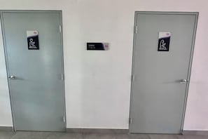 Two doors with signs indicating room numbers 101 and 121. - 121 Residences by manatidur (Petaling Jaya)
