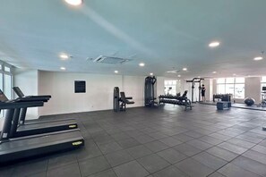 A gym with treadmills, weight machines, and exercise balls. - 121 Residences by manatidur (Petaling Jaya)
