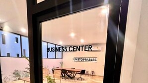 A modern business center with a glass door, a conference table, and a potted plant. - Ipana 1 Bedroom Full Equipped Oceanview Rooftop (Playa del Carmen)