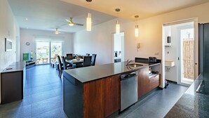 A modern kitchen with a central island, built-in appliances, and pendant lighting. - Penthouse w Private Jacuzzi Steps to 5thav Beach (Playa del Carmen)