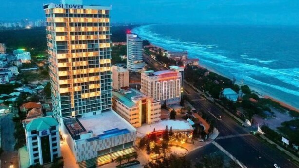 A high-rise hotel with multiple floors and balconies, located near a coastal area with a view of the ocean. - Nha Cua Mang - CSJ Tower Bai Sau Vung Tau (Vung Tau)