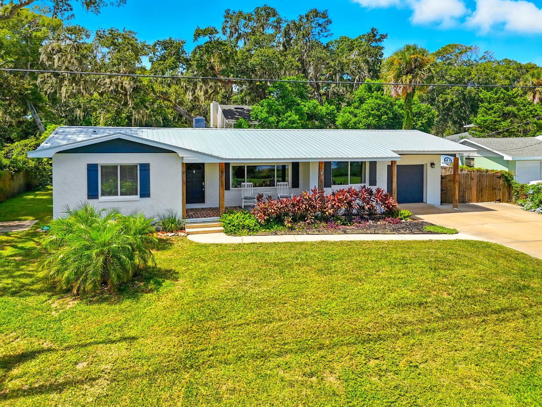 A single-story house with a sloped roof, a front porch, and a well-maintained lawn.