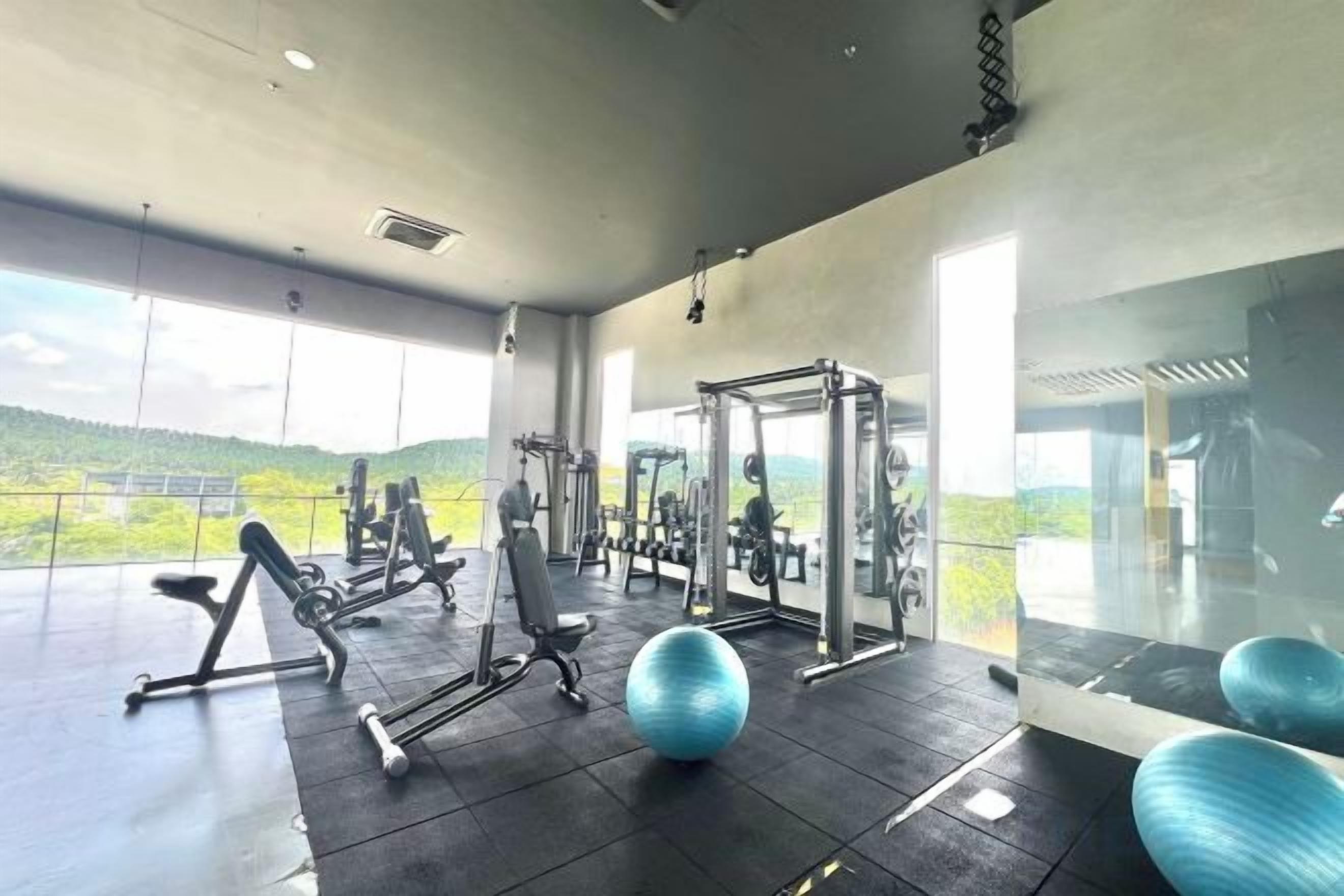 A gym with exercise equipment and a large exercise ball.