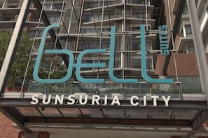 A building with the sign 'GELL' and 'Sunsuria City' indicating a hotel or property.