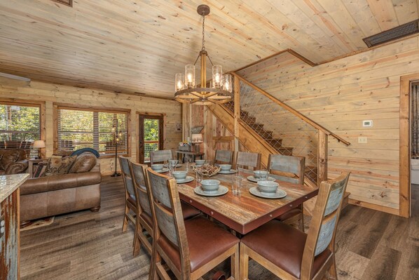 A wooden cabin interior with a dining area, a staircase, and a living room. - Lux Cabin Mtn Views Flat Parking Dog Friendly (Gatlinburg)