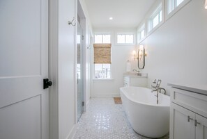 A modern bathroom with a freestanding bathtub, a walk-in shower, and a large window providing natural light. - The Kinsey, 3BR @ Plein Air by Velvet Ditch Villas (Taylor)