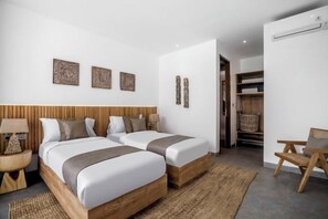 A hotel room with two beds, a desk, and a wardrobe. - Villa Baia by BaliSuperHost (Bali)