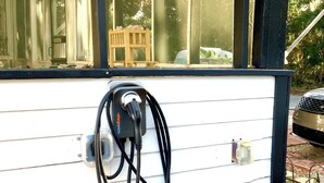 A charging station attached to a building's exterior wall.