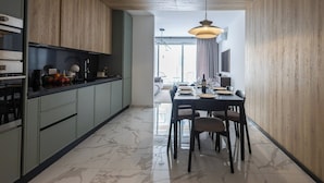 A modern kitchen with a dining area. - Coastal Elegance, Steps from the Sea (Sliema)