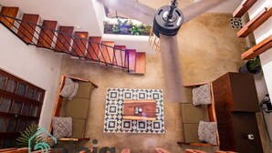 A spa area with wooden benches, a patterned wall, and a staircase. - Strategically located suite with desk (Cancún)