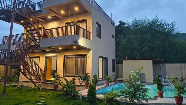 A modern two-story house with a balcony, a staircase, and a swimming pool. - "Kanchan Kutir villa" A Serene Escape in the Heart of Udaipur" (Udaipur)
