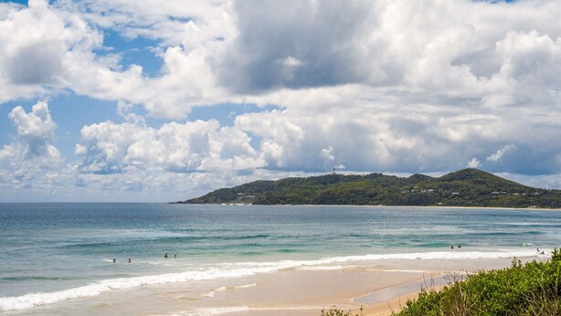 A beach with clear skies and a distant hill. - Studio 9 - Luxury Apartment (Byron Bay)
