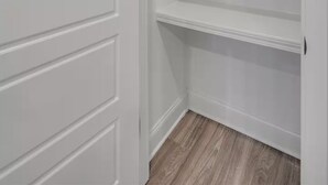 A white closet with three shelves and a door. - Entire 4 Bedroom home in Pearl, Mississippi (Pearl)