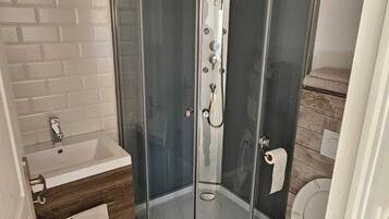 Shower, hair dryer, towels, toilet paper