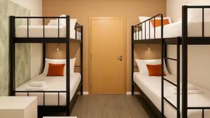 A room with bunk beds, a wooden door, and a small white table.