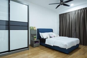 Ein Schlafzimmer mit einem Bett, einem Nachttisch, einem Deckenventilator und einer Schiebetür.