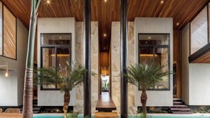 A modern interior with a central pathway, wooden ceiling, and large windows. - Award-Winning 3BR Villa 25m Pool Villa FEH (Bali)
