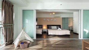 A bedroom with two beds, a window, a tent, and a basket. - Maritime Seaview Comfy Suite in Penang with TVbox.Pool.Wifi (George Town)