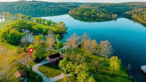 An aerial view of a lakeside property with a red marker indicating a specific location. - Wren Cabin - Private Hot Tub, Fireplace, and Lake View (Forsyth)
