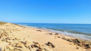 A beach with rocky terrain and a clear blue sky. - 🌴 "Blue Horizon at Surf Club" 🌅 Ocean Views 3rd Floor Corner Wraparound Balcony! (Palm Coast)