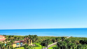 A coastal resort with a clear view of the ocean, a pool area, and a well-maintained garden with palm trees. - 🌴 "Blue Horizon at Surf Club" 🌅 Ocean Views 3rd Floor Corner Wraparound Balcony! (Palm Coast)