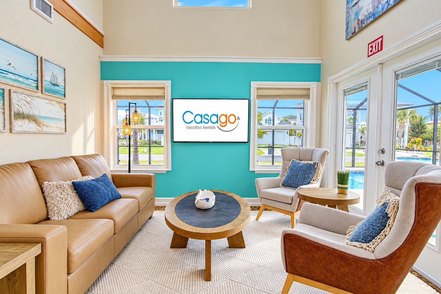 A modern lounge area with a teal accent wall, a sign for Casago Vacation Rentals, and a view of the outdoors.