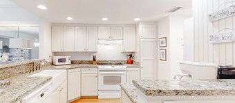 Dog-friendly oceanfront townhouse with covered balcony, views, pool & AC