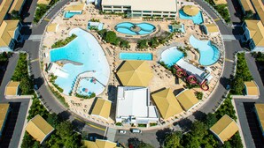 An aerial view of a resort with multiple swimming pools, a central building, and surrounding villas. - diRoma Lacqua Caldas Novas (Caldas Novas)