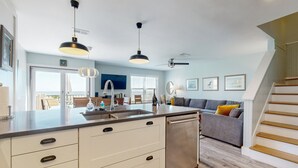 A modern kitchen with a central island, built-in appliances, and pendant lighting. - Lovely oceanfront townhouse in Summer Beach Village w/Shared Pool, Central AC (Fernandina Beach)