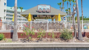 A restaurant named 'Cruzan Rum Shack' with outdoor seating and a view of a hotel in the background.