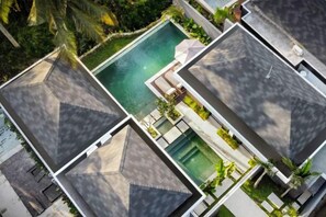 A resort with multiple buildings, a central swimming pool, and lush greenery. - Villa Ornella by BaliSuperHost (Bali)