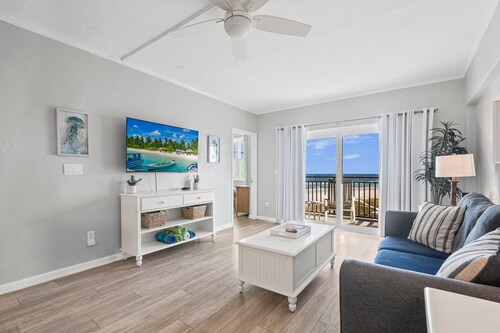 Polished oceanfront condo with pool access, private balcony & washer/dryer