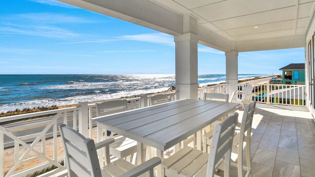 A covered outdoor seating area with a view of the ocean. - Brand new oceanfront home with private hot tub,outdoor shower and grill (Flagler Beach)